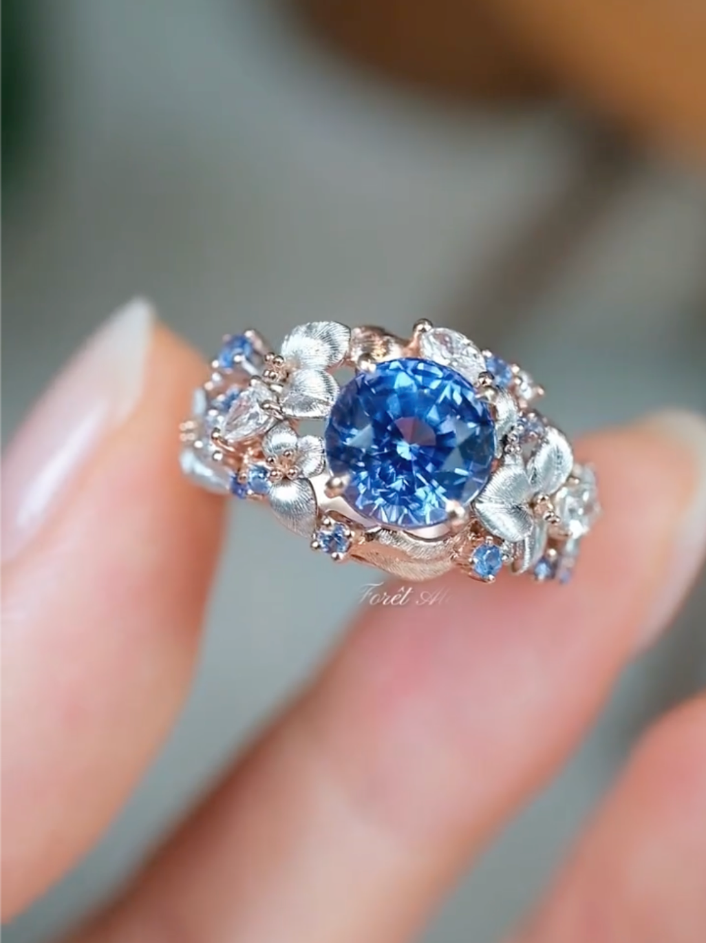Celestielle Floral Halo Blue Sapphire Ring with rose gold and white gold setting