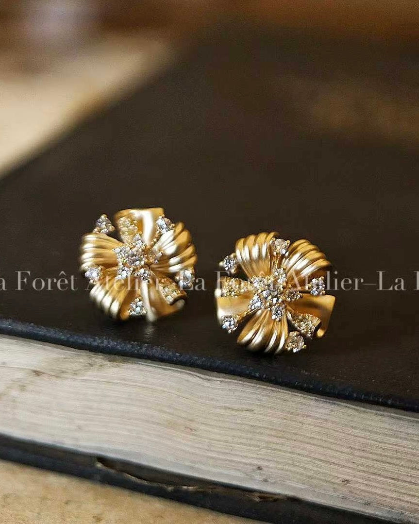 Vintage floral earrings with twisted gold ribbons and lab-grown diamond centers
