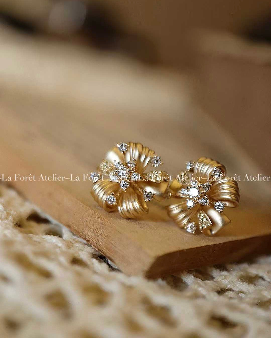 Vintage floral earrings with twisted gold ribbons and lab-grown diamond centers

