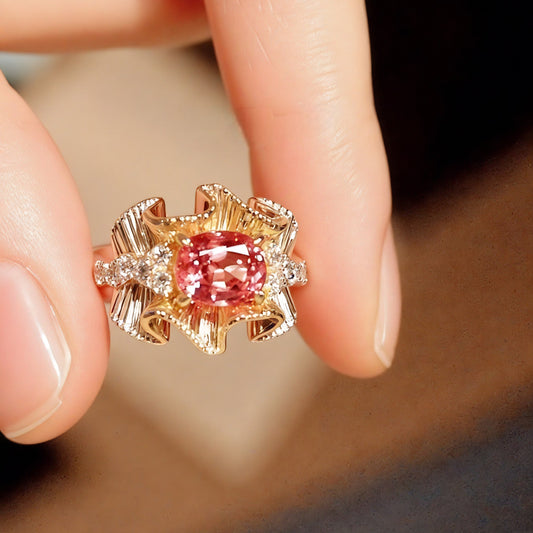 Ribbon-style ring with peach-pink Padparadscha sapphire

