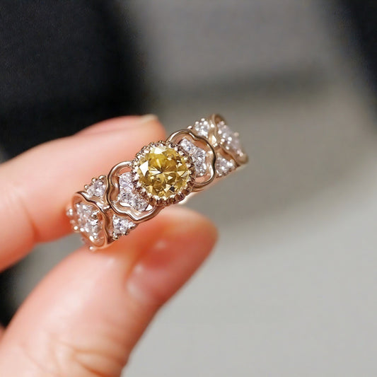 Yellow lab diamond ring with heart-motif rose gold band

