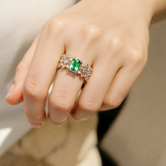 Emerald-cut tsavorite ring with lab diamond cluster band

