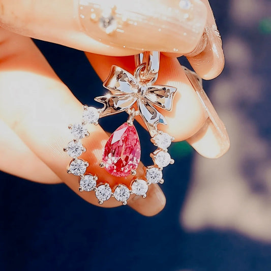 Rose gold bow pendant with pink Padparadscha sapphire
