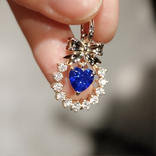 Heart-shaped lab sapphire pendant with bow

