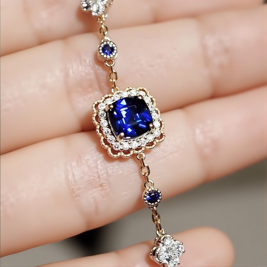 Soraya gold bracelet featuring 2ct lab royal blue sapphire with diamond halo and gemstone accents








