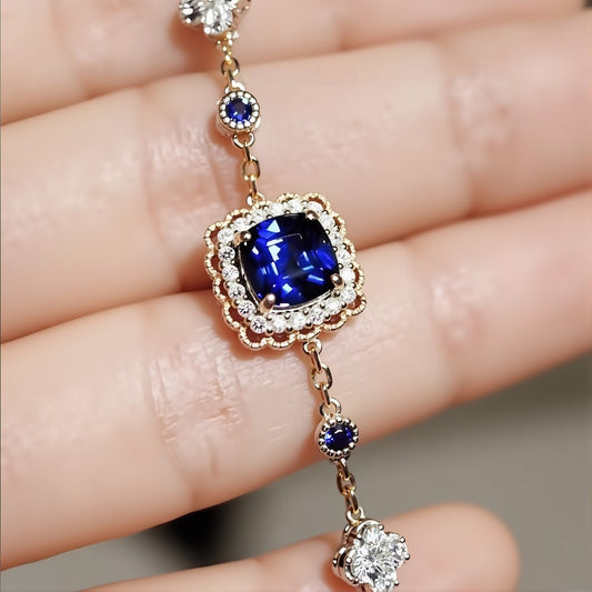 Soraya gold bracelet featuring 2ct lab royal blue sapphire with diamond halo and gemstone accents








