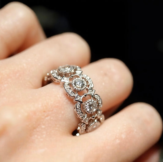 Eternity band ring with lab-grown diamonds and tourmalines in circular halo setting









