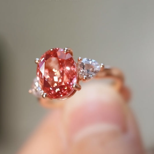 Annelise rose gold ring with 2.5ct lab padparadscha sapphire and pear lab diamond side stones








