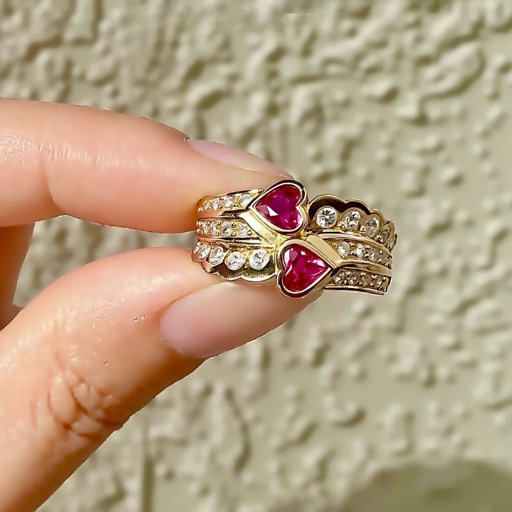 Gold crown ring with heart-shaped lab rubies and diamond accents
