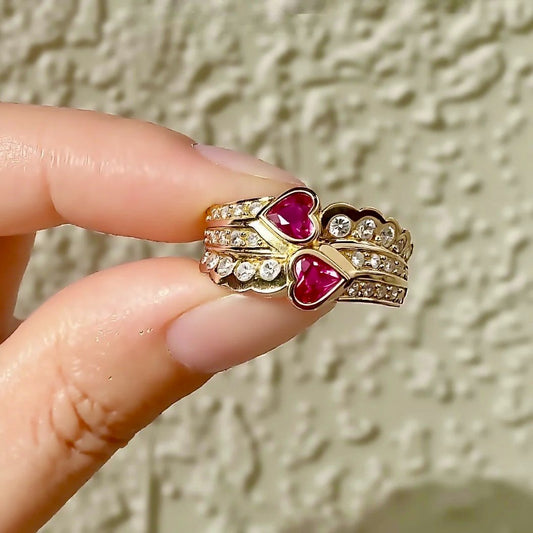 Gold crown ring with heart-shaped lab rubies and diamond accents
