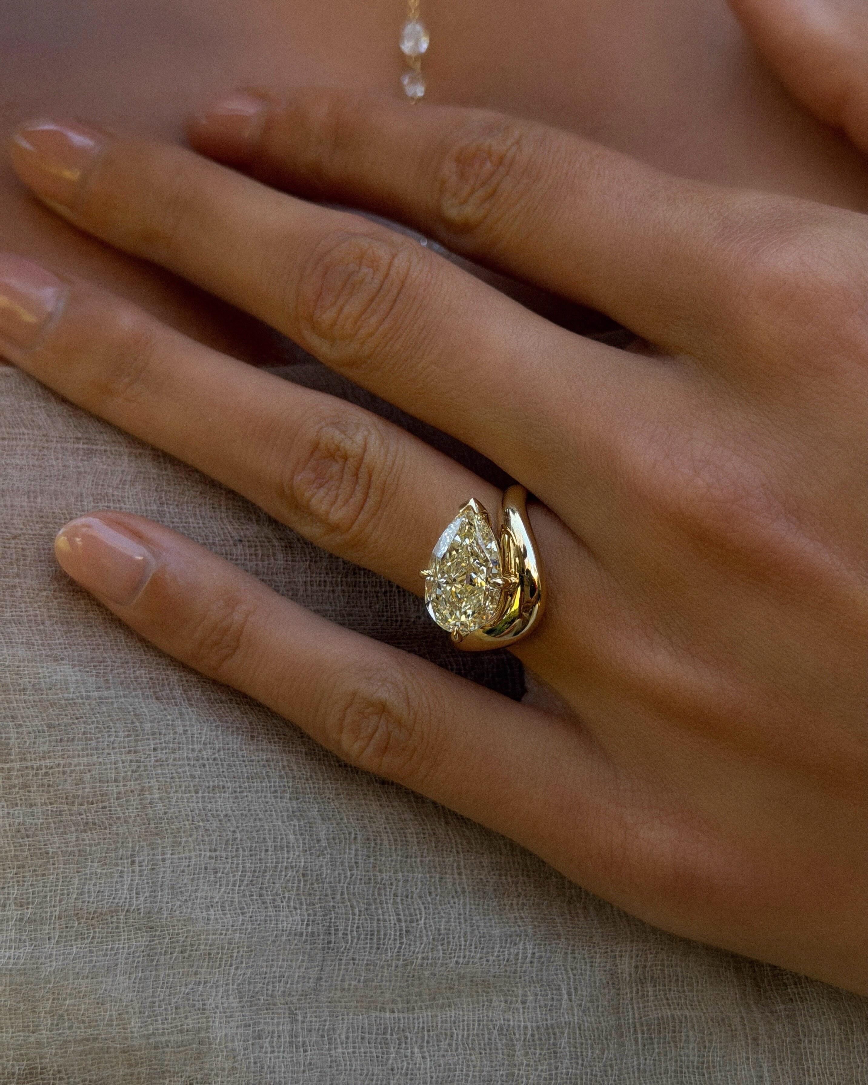 Calivienne Fancy Light Yellow Diamond Ring by La Forêt, featuring a pear cut diamond in a sculpted gold setting.