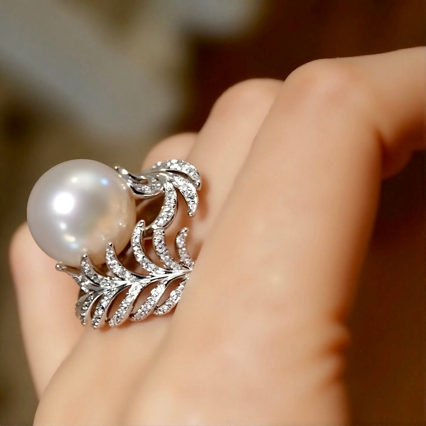 Natural pearl ring with 12–13mm white pearl and diamond wave leaf setting








