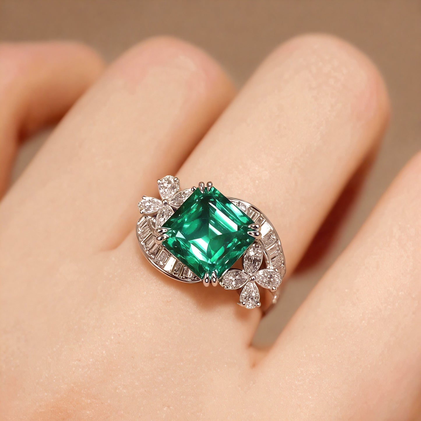 Emerald-cut green stone ring with floral diamond halo

