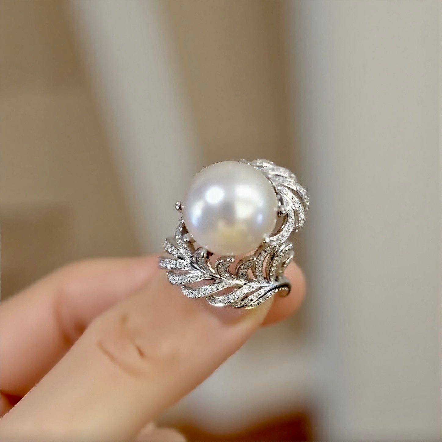 Natural pearl ring with 12–13mm white pearl and diamond wave leaf setting








