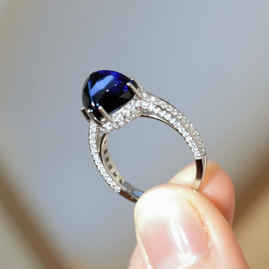 7ct lab-grown royal blue sugarloaf sapphire ring with pavé lab diamonds and split band setting








