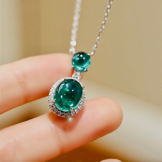 Nirelle pendant necklace with 3ct and 1ct lab-grown emerald cabochons and diamond halo in white gold

















