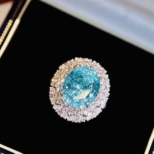Oval Paraiba halo ring with white gold and sparkling beadwork

