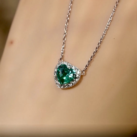 Heart-shaped 1ct lab-grown emerald necklace with diamond halo on silver chain
