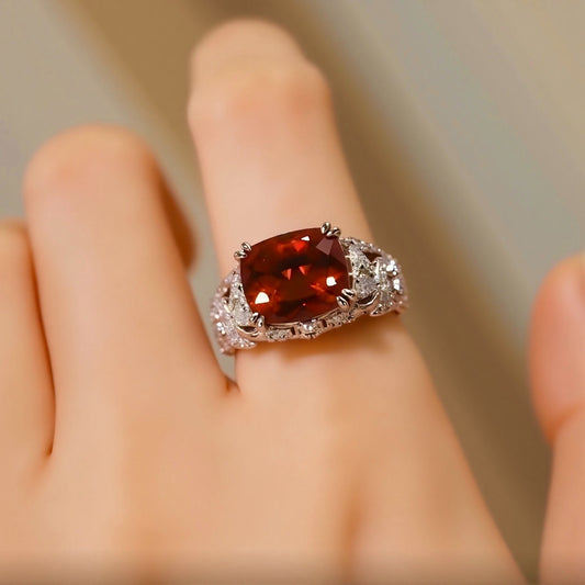 Vintage-style lab-grown ruby ring with cushion-cut center and pavé diamonds in white gold
