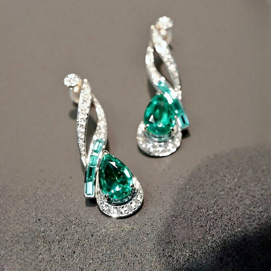 Nyelle earrings with 2ct lab emerald teardrops, baguette accents and pavé setting








