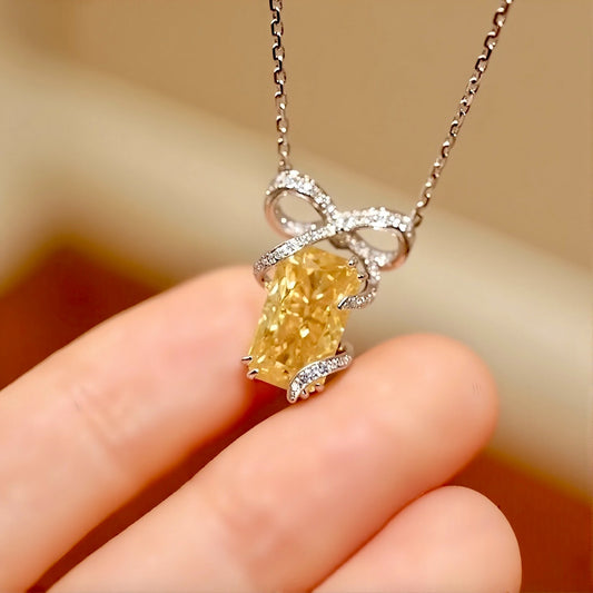 Radiant-cut 3.5ct yellow lab-grown diamond necklace with diamond bow setting
