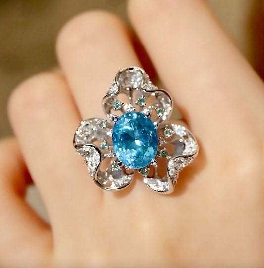 Floral-inspired ring with a 5ct natural apatite center and shimmering diamond petals








