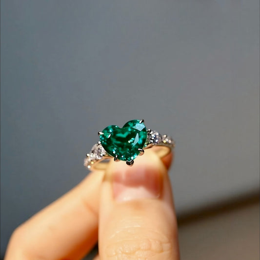 White gold ring with heart-shaped 2.5ct lab-grown emerald and lab diamond accents








