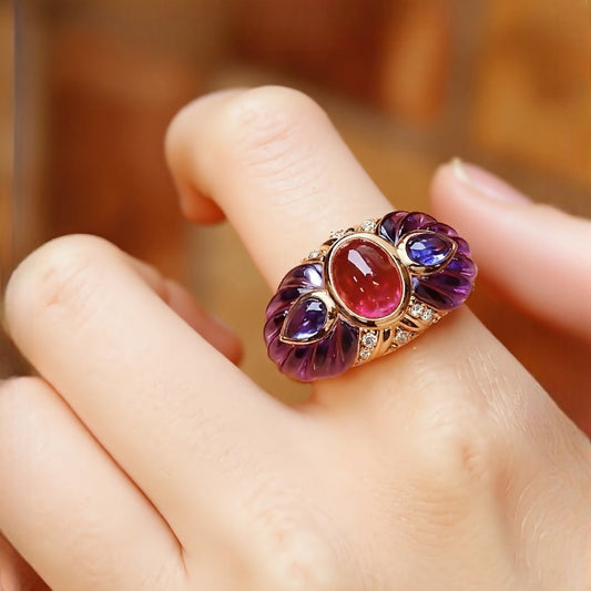 Gold statement ring with natural pink tourmaline cabochon, carved amethyst petals, and diamond accents








