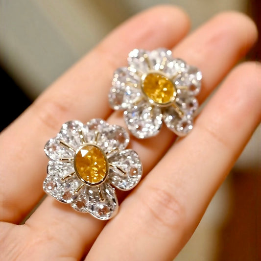 Flora Aurelia earrings feature 1ct lab-grown yellow diamonds with rose-cut lab diamond petals in a radiant floral design.








