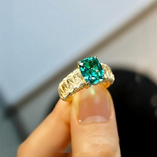 The Emerelle ring features a radiant 2ct lab grown emerald on a textured quilted gold band—a bold, elegant statement of timeless design.

