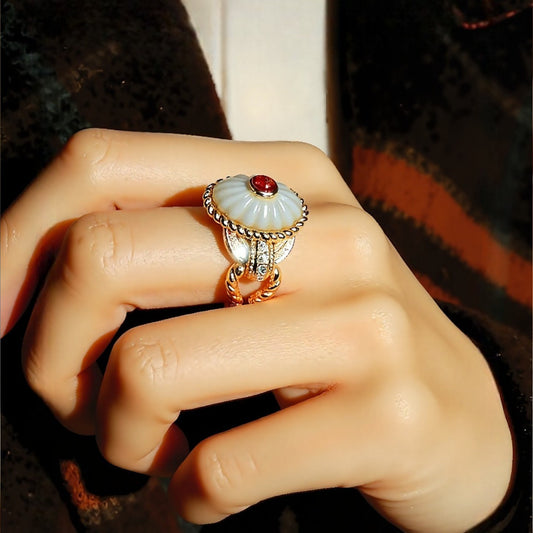 Statement ring with lab-grown ruby and carved mother-of-pearl dome with gold and diamond accents









