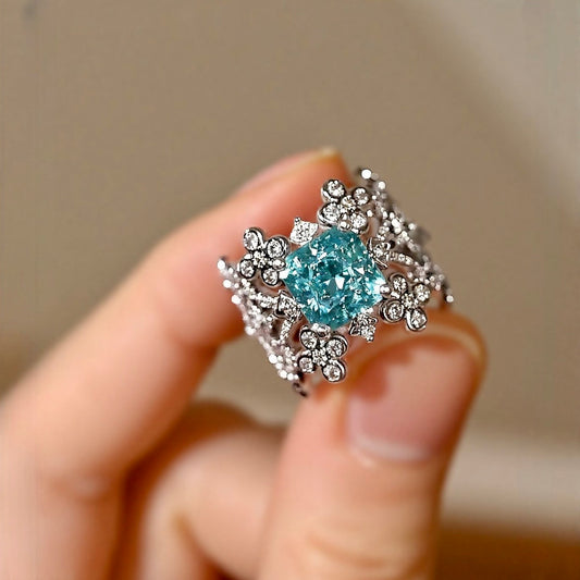 Lab grown blue diamond floral ring with intricate filigree design

