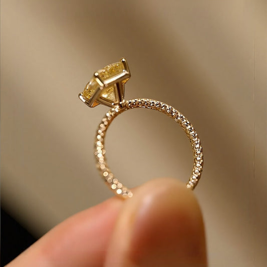 3ct radiant yellow lab-grown diamond solitaire ring with pavé diamond band in yellow gold









