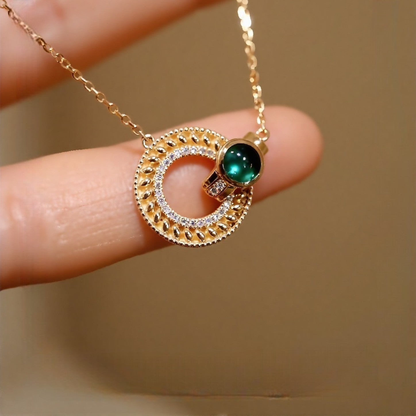 Gold medallion necklace with lab emerald cabochon and pavé diamond accents








