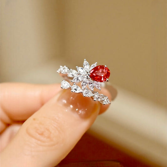 Pear-cut lab sapphire ring with diamond leaf design in white gold








