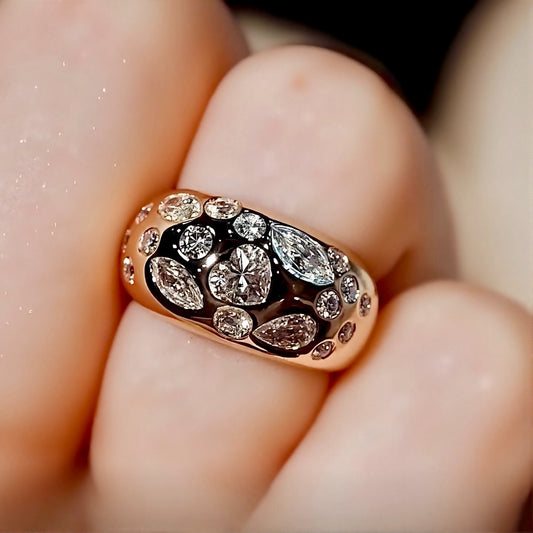 Close-up of Celeste gold dome ring with pear and marquise diamonds