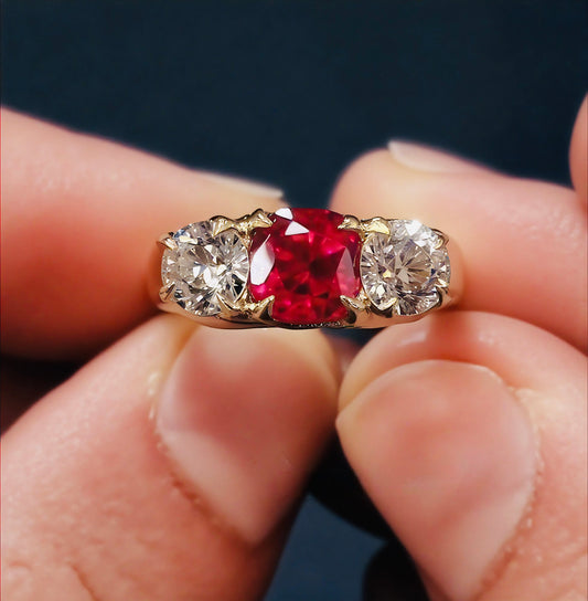 Three-stone ring with lab pigeon blood ruby center

