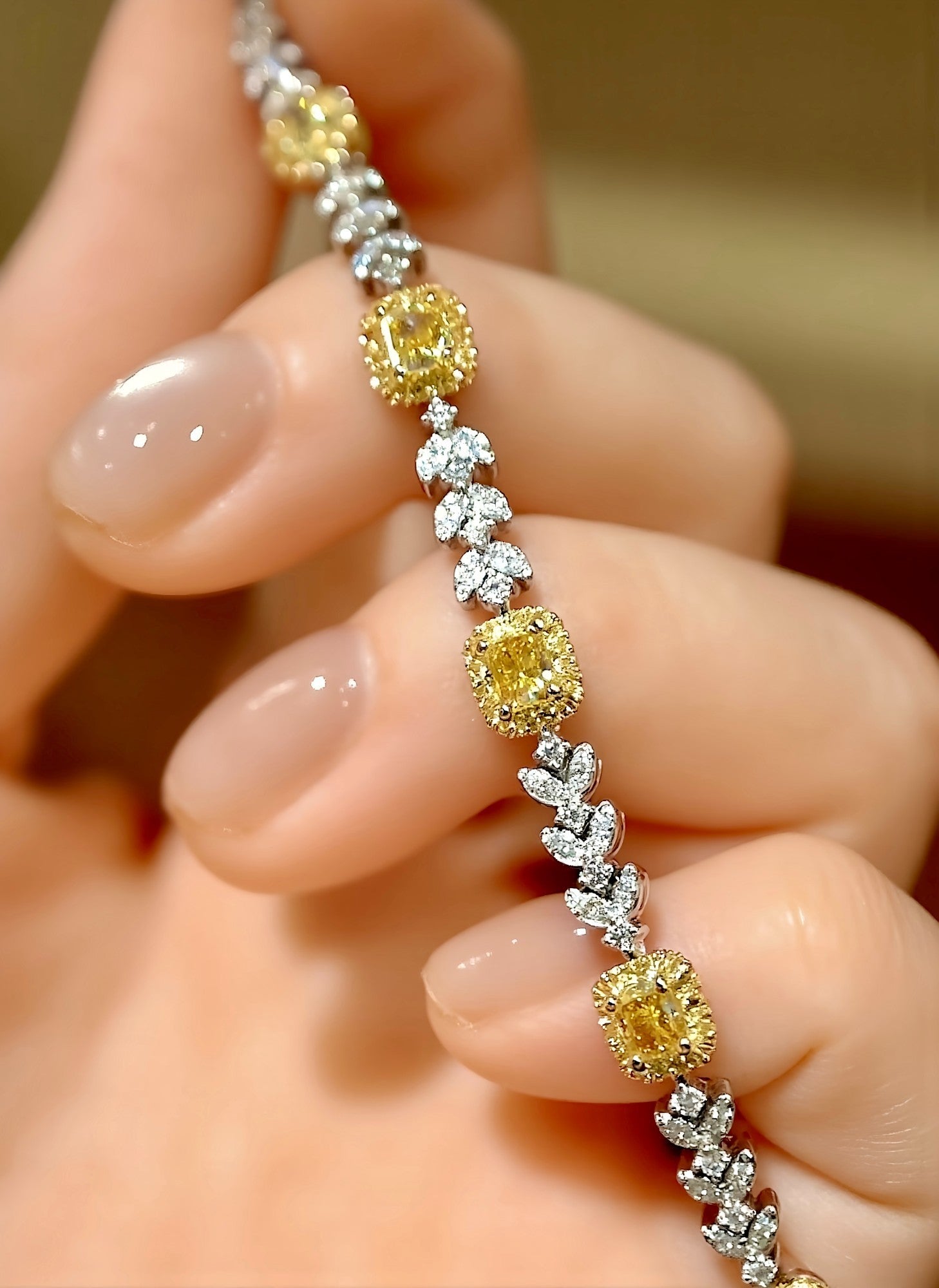 Ulara bracelet with lab-grown cushion yellow diamonds and marquise white diamonds in an 18K gold leaf motif – elegant tennis bracelet

