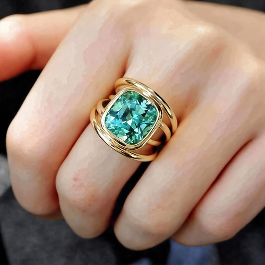 Modern gold ring with cushion-cut teal tourmaline

