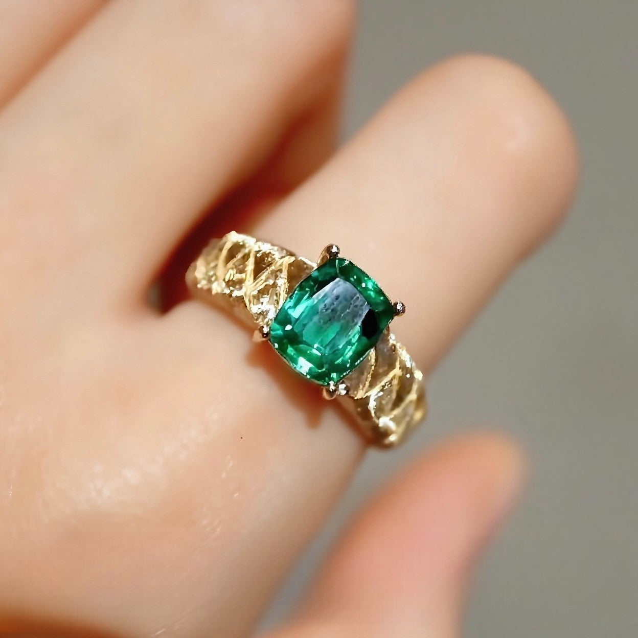Rivelle ring with 2ct cushion-cut lab emerald set on a woven textured gold band
