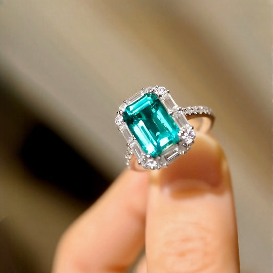 Radiant 3ct emerald-cut lab-grown emerald ring with halo diamonds in white gold









