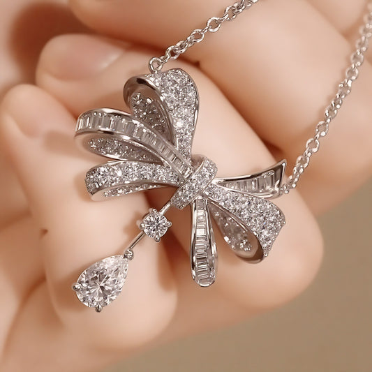 Lab diamond bow pendant with pear drop accent

