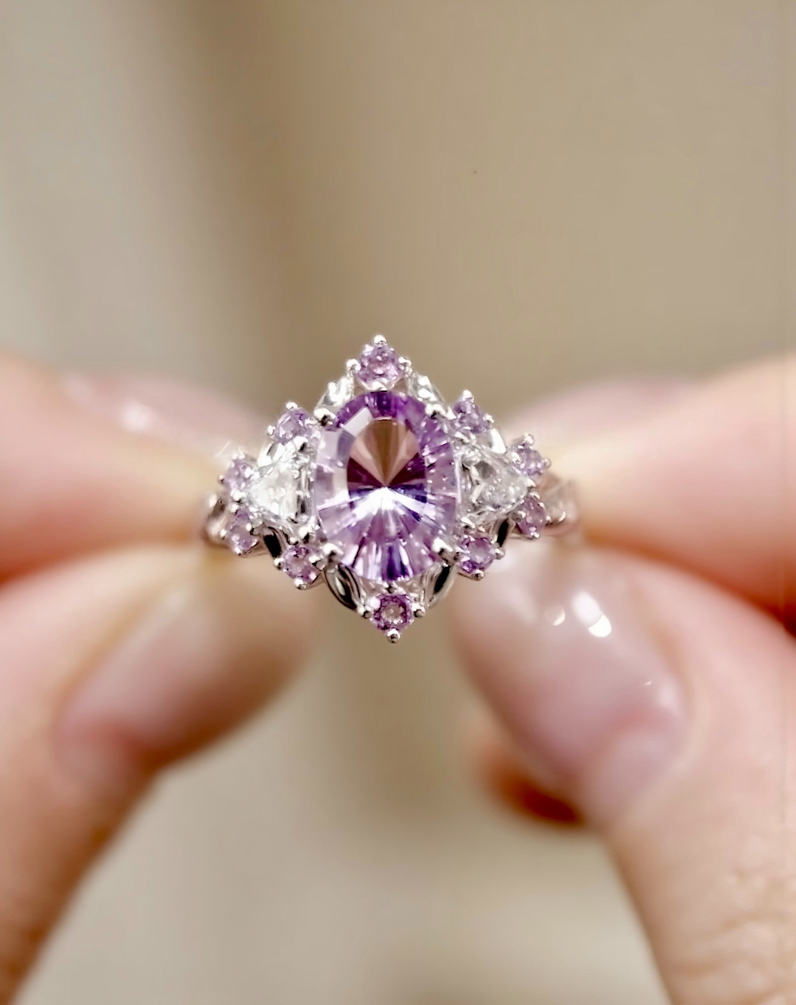 Jaevia ring featuring 1ct lavender lab sapphire with pink sapphires and diamond halo








