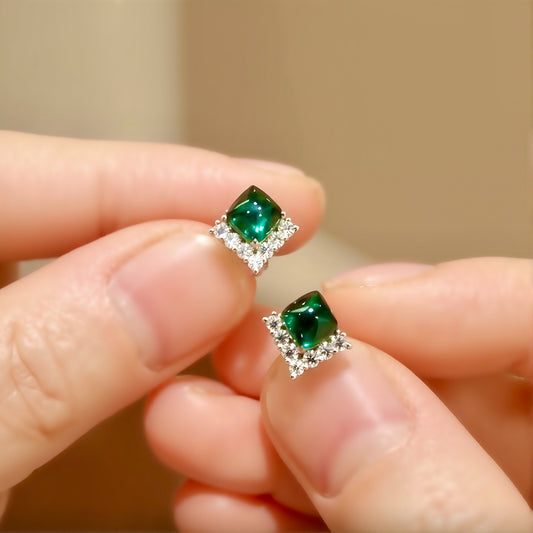 Cushion-cut sugarloaf lab emerald earrings with diamond halo in white gold setting
