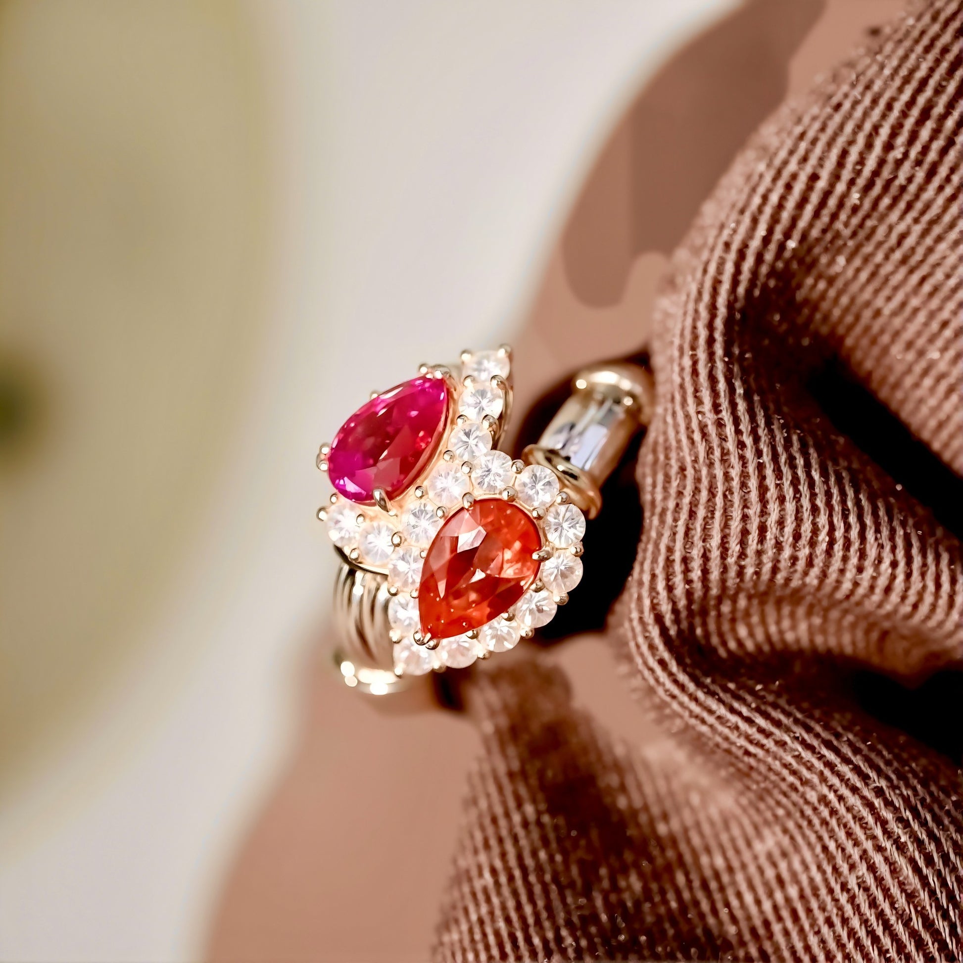 Toi et Moi gold ring with pear-cut lab pink diamond and padparadscha sapphire surrounded by diamond halos