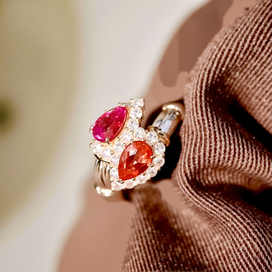 Toi et Moi gold ring with pear-cut lab pink diamond and padparadscha sapphire surrounded by diamond halos
