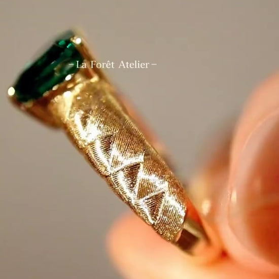Heart-cut lab emerald ring with quilted gold band
