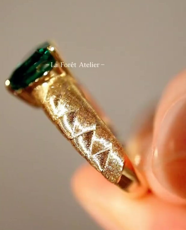 Heart-cut lab emerald ring with quilted gold band
