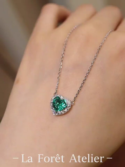 Heart-shaped 1ct lab-grown emerald necklace with diamond halo on silver chain








