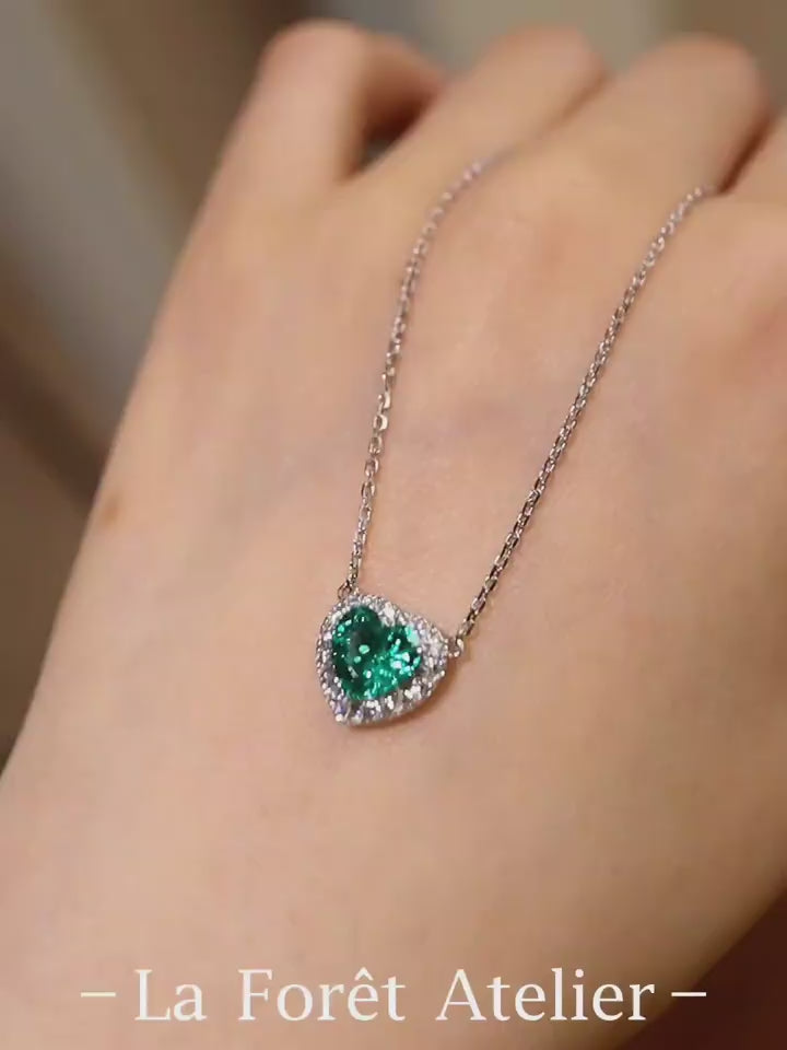 Heart-shaped 1ct lab-grown emerald necklace with diamond halo on silver chain








